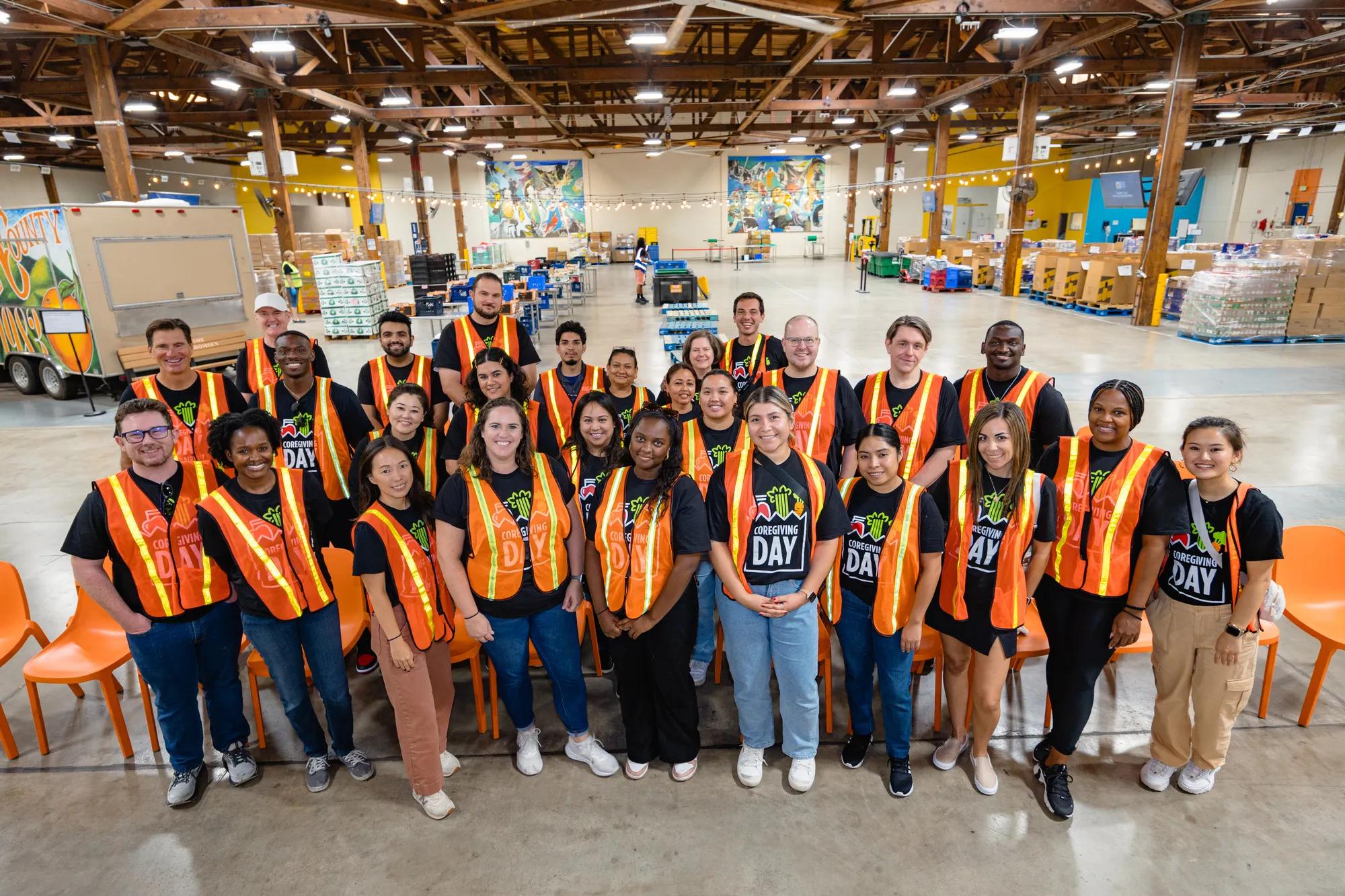 Link Logistics employee volunteers in orange vests on CoreGiving 2025 day in Irvine, California