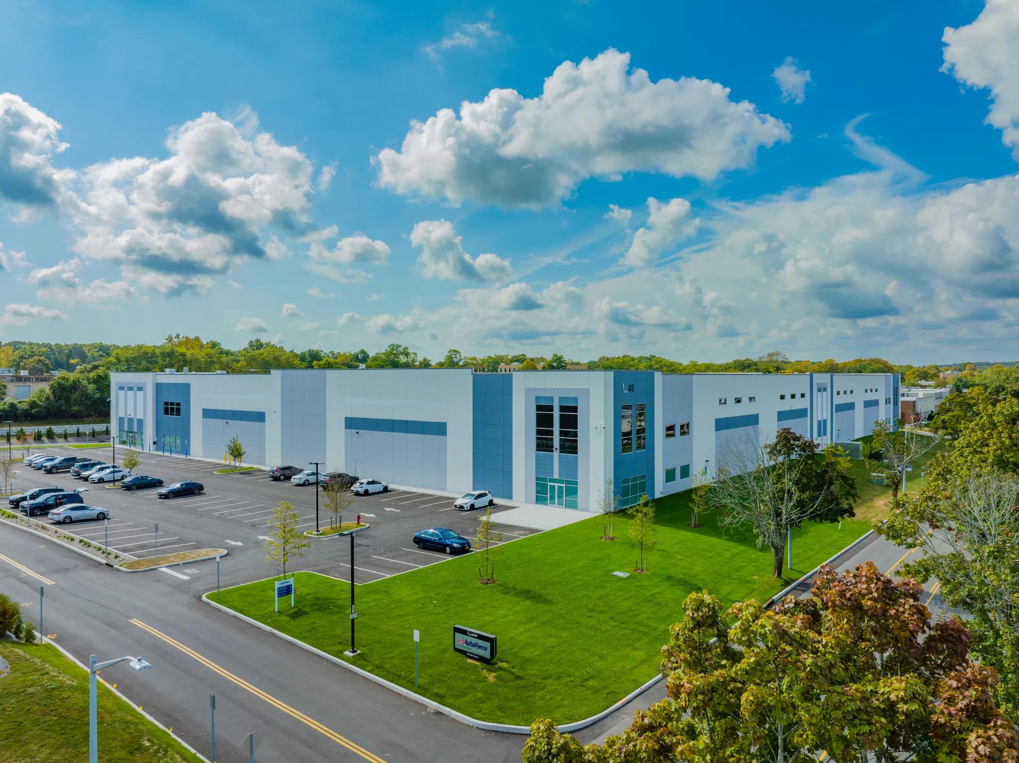 Blue skies over Link Logistics industrial warehouse Northern Oak Logistics Center Building IV on Long Island, NY